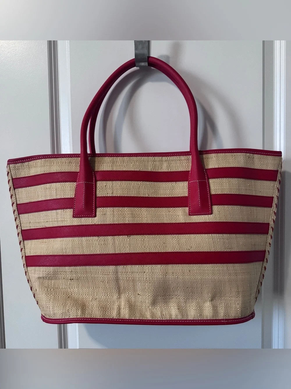 Tory Burch straw tote features vibrant red leather stripes